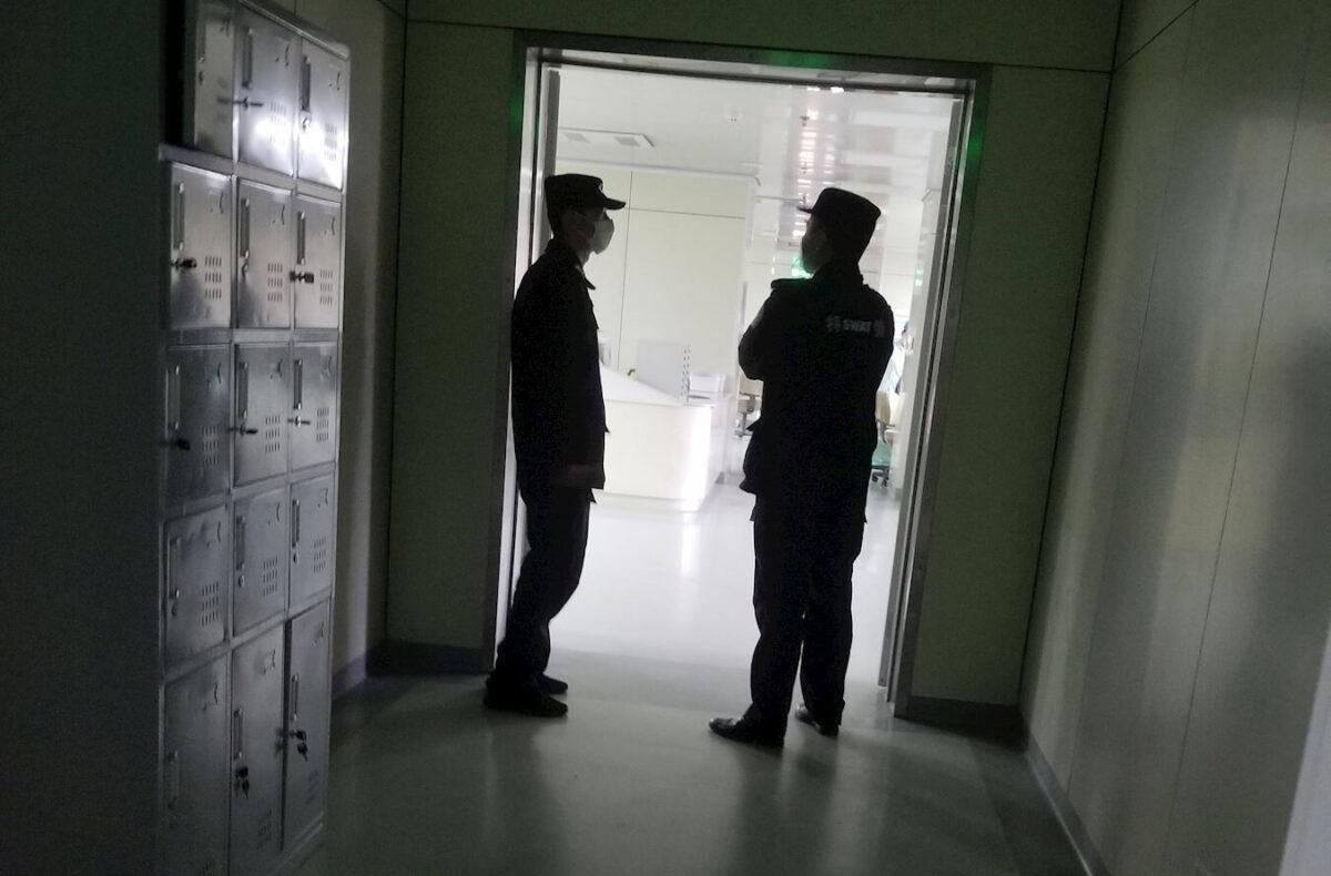 Police monitoring the ICU unit where Falun Gong practitioner Yao Xinren was being treated, in Longkou city, Shandong Province, China. (Courtesy of Minghui.org)