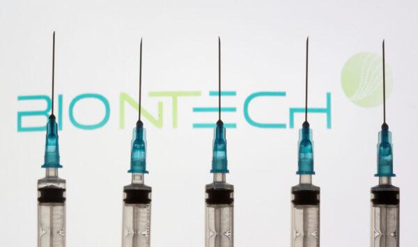Syringes in front of a displayed BioNTech logo in this illustration taken Nov. 10, 2020. (Dado Ruvic/Reuters)