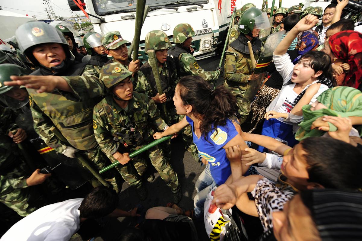 Ethnic Uygur women protest during a demonstration in Urumqi in China's far west Xinjiang Province on July 7, 2009. (Peter Parks/AFP via Getty Images)