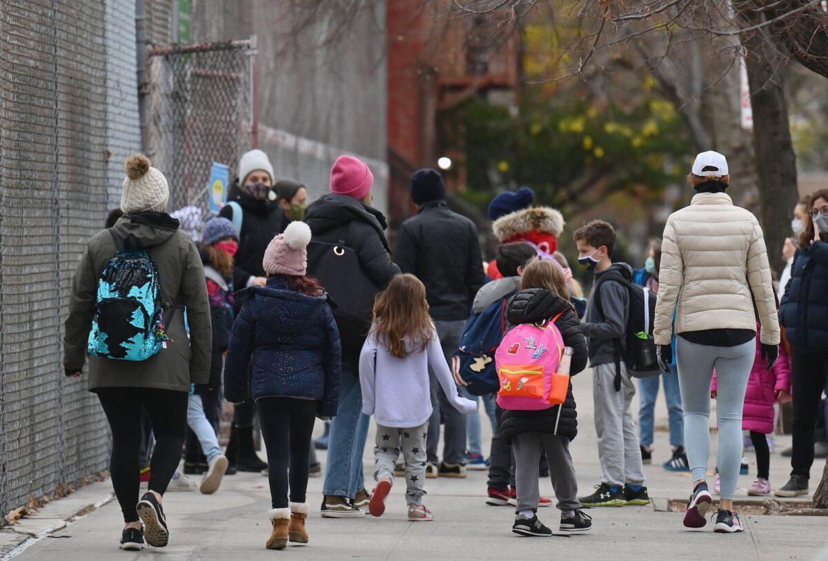 Children arrive for class on the first day of school reopening in Brooklyn, New York City, N.Y., on Dec. 7, 2020. (Angela Weiss/AFP via Getty Images)