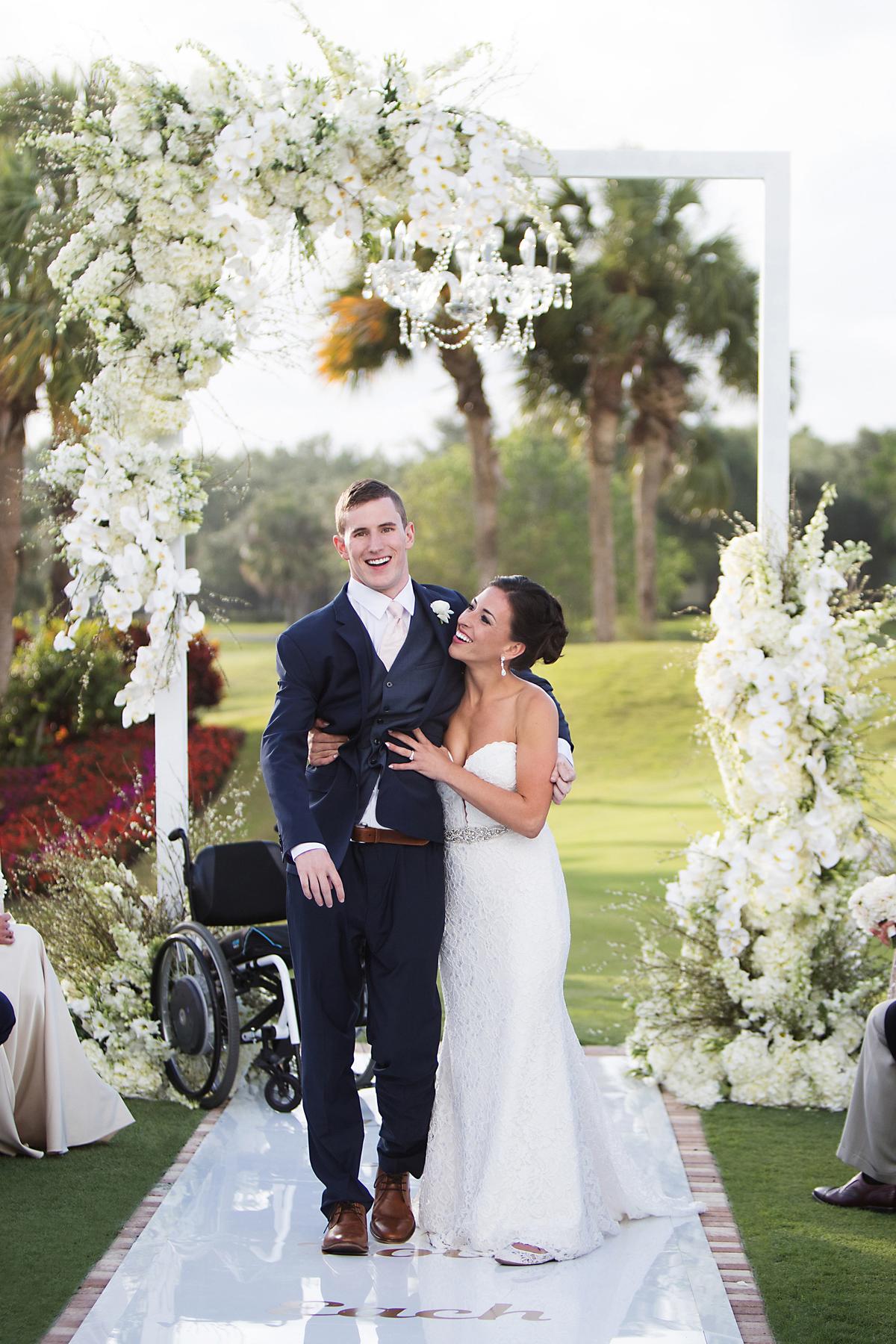 Chris Norton walking down the aisle with his wife, Emily Summers, in Jupiter, Fla., on April 21, 2018. (Courtesy of Sarah Kate/Fotolanthropy)