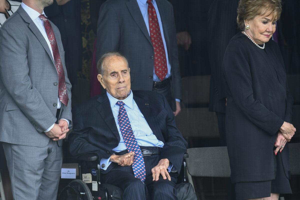  Former Sen. Bob Dole and wife Elizabeth Dole wait as President Donald Trump arrives to participate in the Armed Forces Welcome Ceremony in honor of the 20th Chairman of the Joint Chiefs of Staff at Summerall Field, Joint Base Myer-Henderson Hall, Va., on Sept. 30, 2019. (Brendan Smialowski/AFP via Getty Images)