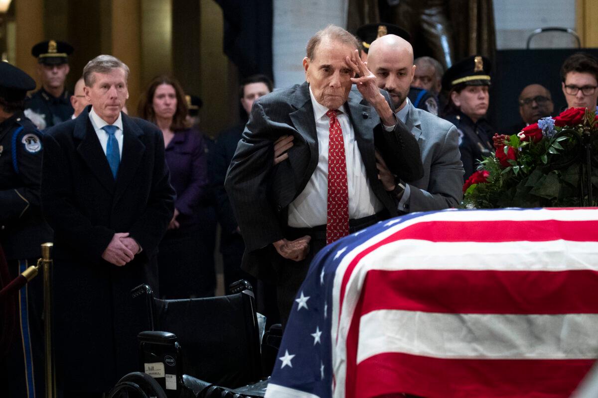 Former Sen. Bob Dole stands up to salute the casket of the late former President George H.W. Bush at the U.S. Capitol, in Washington on Dec. 4, 2018. (Drew Angerer/Getty Images)