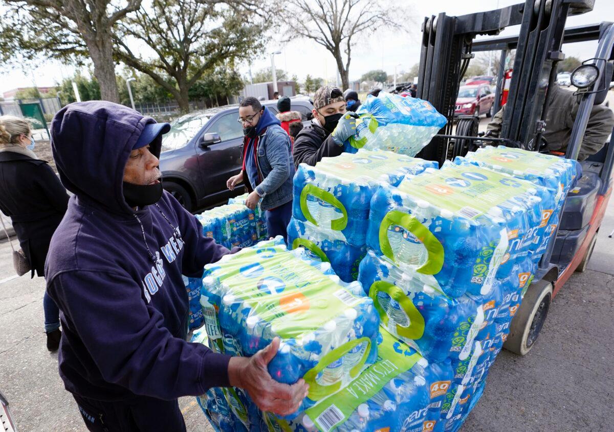Donated water is unloaded at a distribution site in Houston, Texas, on Feb. 18, 2021. (David J. Phillip/AP Photo)