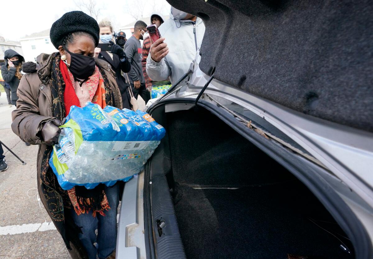 Rep. Sheila Jackson Lee (D-Texas) loads donated water into a car at a distribution site in Houston, Texas, on Feb. 18, 2021. (David J. Phillip/AP Photo)