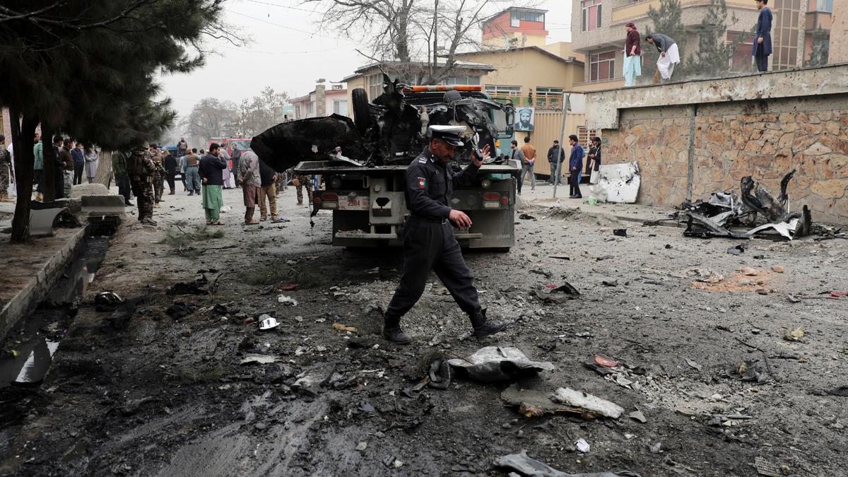 Security personnel inspect the site of a bomb attack in Kabul, Afghanistan, on Feb. 20, 2021. (Rahmat Gul/AP)
