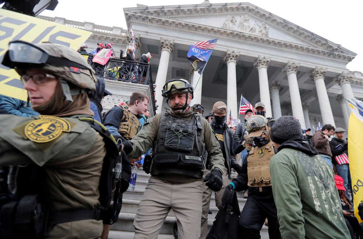 Jessica Watkins (Left) and Donovan Ray Crowl (Center), both from Ohio, march down the East front steps of the U.S. Capitol with the Oath Keepers group in Washington, Jan. 6, 2021. (Reuters/Jim Bourg)