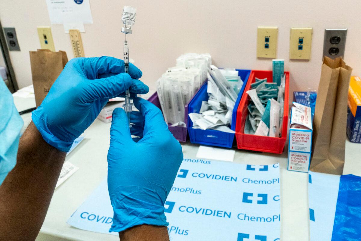 A pharmacist prepares a syringe with the Pfizer-BioNTech COVID-19 vaccine at a COVID-19 vaccination site at NYC Health + Hospitals Metropolitan, New York, on Feb. 18, 2021. (Mary Altaffer/AP Photo)