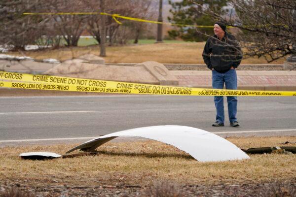 A piece of debris from a commercial airplane is surrounded by police tape on a strip along Midway Boulevard in Broomfield, Colo., on Feb. 20, 2021. (David Zalubowski/AP Photo)