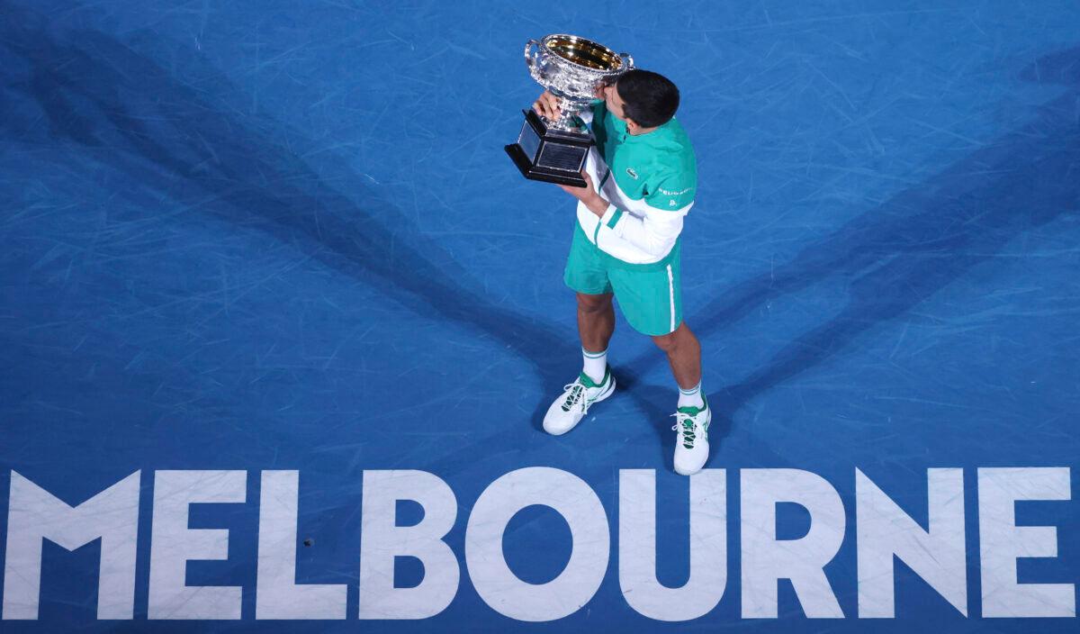 Serbia's Novak Djokovic kisses the Norman Brookes Challenge Cup after defeating Russia's Daniil Medvedev in the men's singles final at the Australian Open tennis championship in Melbourne, Australia, on Feb. 21, 2021. (Hamish Blair/AP Photo)