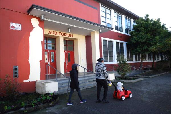 Pedestrians pass a mural of Abraham Lincoln outside of Abraham Lincoln High School in San Francisco, on Dec. 17, 2020. (Justin Sullivan/Getty Images)