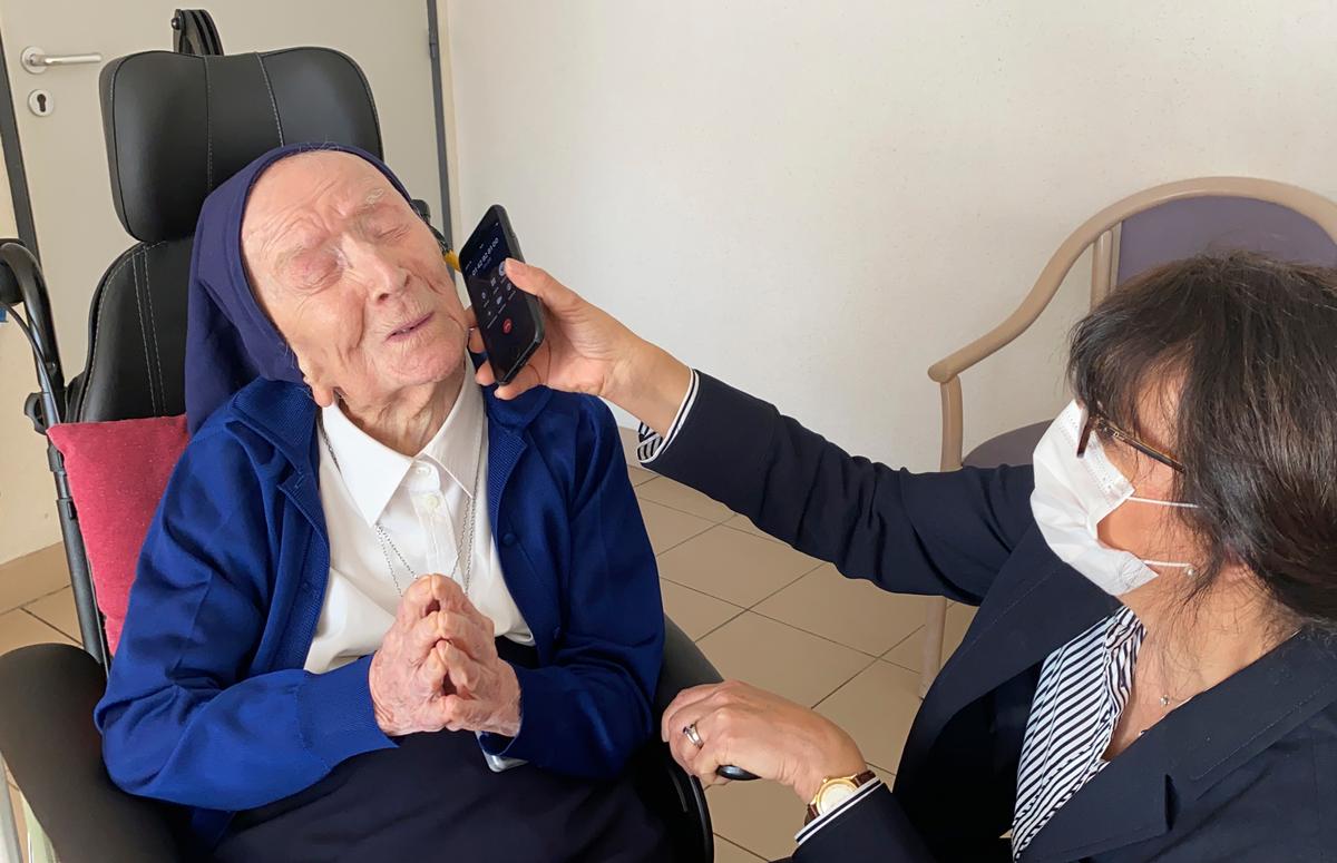 Sister André speaks on the phone in Toulon, southern France, Thursday, Feb. 11, 2021. (Sainte-Catherine Laboure care home/David Tavella via AP)
