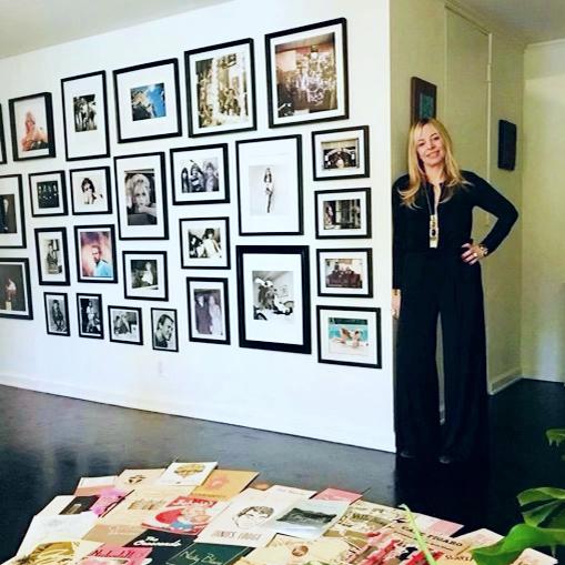 Alison Martino stands next to a wall of framed photos in her home. (Courtesy of Alison Martino)