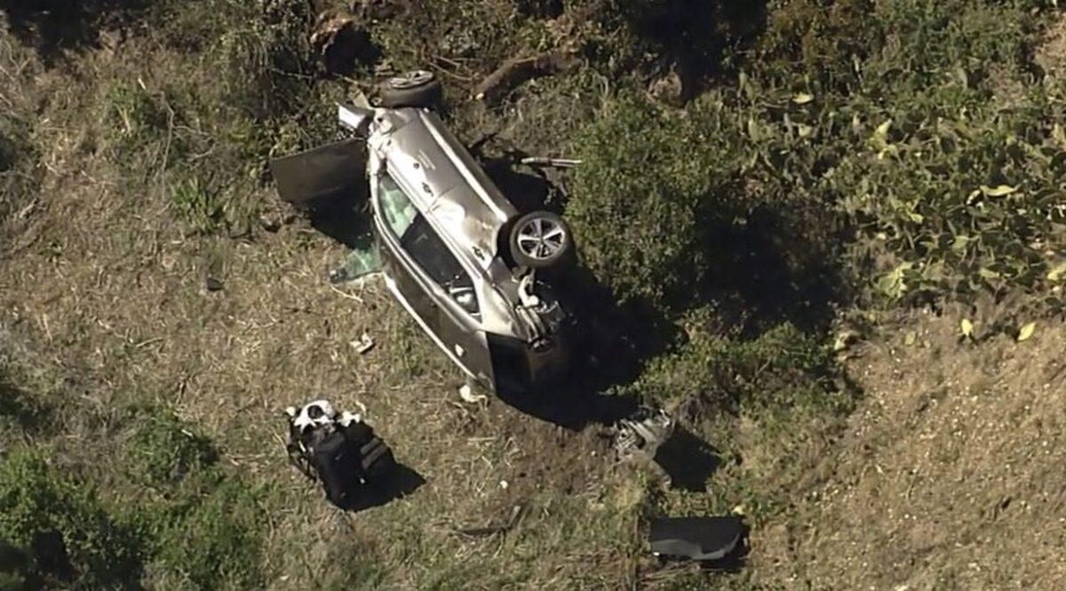 A vehicle rests on its side after a rollover accident involving golfer Tiger Woods along a road in the Rancho Palos Verdes section of Los Angeles, Calif., on Feb. 23, 2021. (KABC-TV via AP)