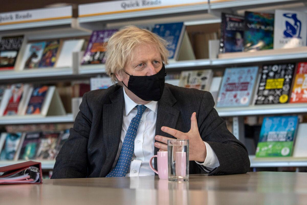 Prime Minister Boris Johnson meets teachers in the library as he visits Sedgehill School in southeast London, UK, on Feb. 23, 2021. (Jack Hill/WPA Pool/Getty Images)