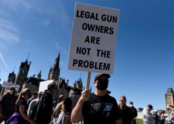 A gun owner holds a sign as they participate in a rally organized by the Canadian Coalition for Firearm Rights against the government's new gun regulations, on Parliament Hill in Ottawa, on Sept. 12, 2020. (Justin Tang/The Canadian Press)