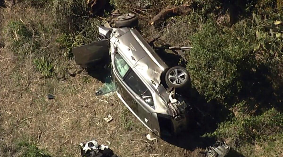 A vehicle rest on its side after a rollover accident involving golfer Tiger Woods along a road in the Rancho Palos Verdes section of Los Angeles on Feb. 23, 2021. (KABC-TV via AP)