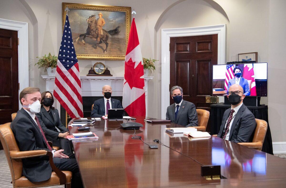 President Joe Biden, with Vice President Kamala Harris (2nd L), national security adviser Jake Sullivan (L), Secretary of State Antony Blinken (2nd R), and Deputy Assistant Secretary of State for Western Hemisphere Affairs Juan Gonzalez (R) hold a virtual bilateral meeting with Canadian Prime Minister Justin Trudeau (on screen) in the Roosevelt Room of the White House in Washington on Feb. 23, 2021. (Saul Loeb/AFP via Getty Images)