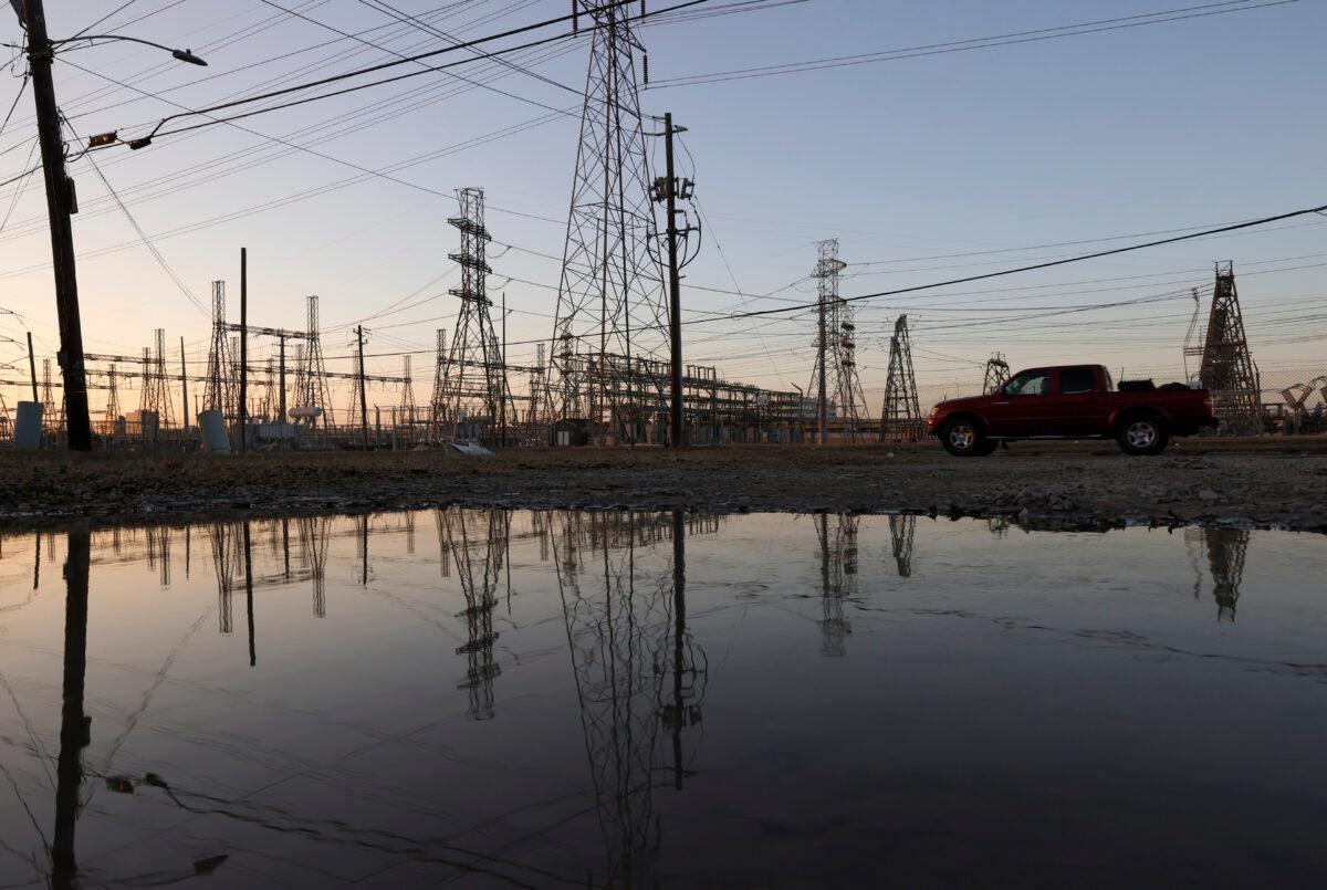 An electrical substation is reflected in water in Houston, Texas on Feb. 21, 2021. (Justin Sullivan/Getty Images)
