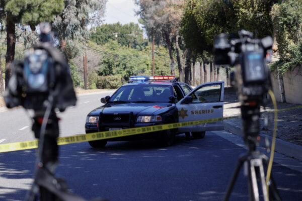 A police car is seen on a road in the vicinity of a scene where Tiger Woods was involved in a car crash, near Los Angeles, Calif., on Feb. 23, 2021. (Mario Anzuoni/Reuters)
