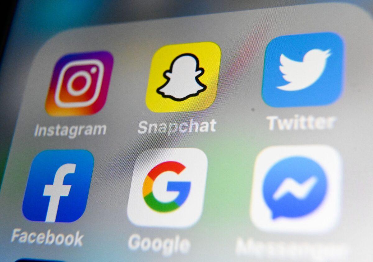 The logos of mobile apps Instagram, Snapchat, Twitter, Facebook, Google, and Messenger displayed on a tablet on Oct. 1, 2019. (Denis Charlet/AFP via Getty Images)