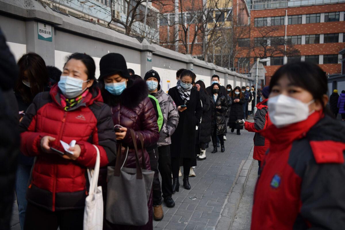 People line up to be tested for COVID-19, part of a drive to test two million people in 48 hours as the city rushes to snuff out a new local cluster of cases believed to be linked to a more contagious virus variant in Beijing on Jan. 22, 2021. (Greg Baker/AFP via Getty Images)