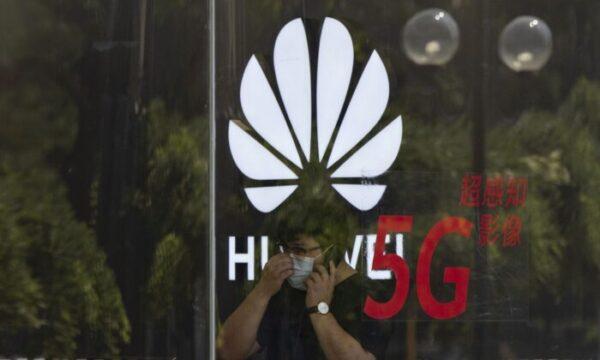 A worker talks on the phone in a Huawei store in Beijing on July 15, 2020. (AP Photo/Ng Han Guan, File)