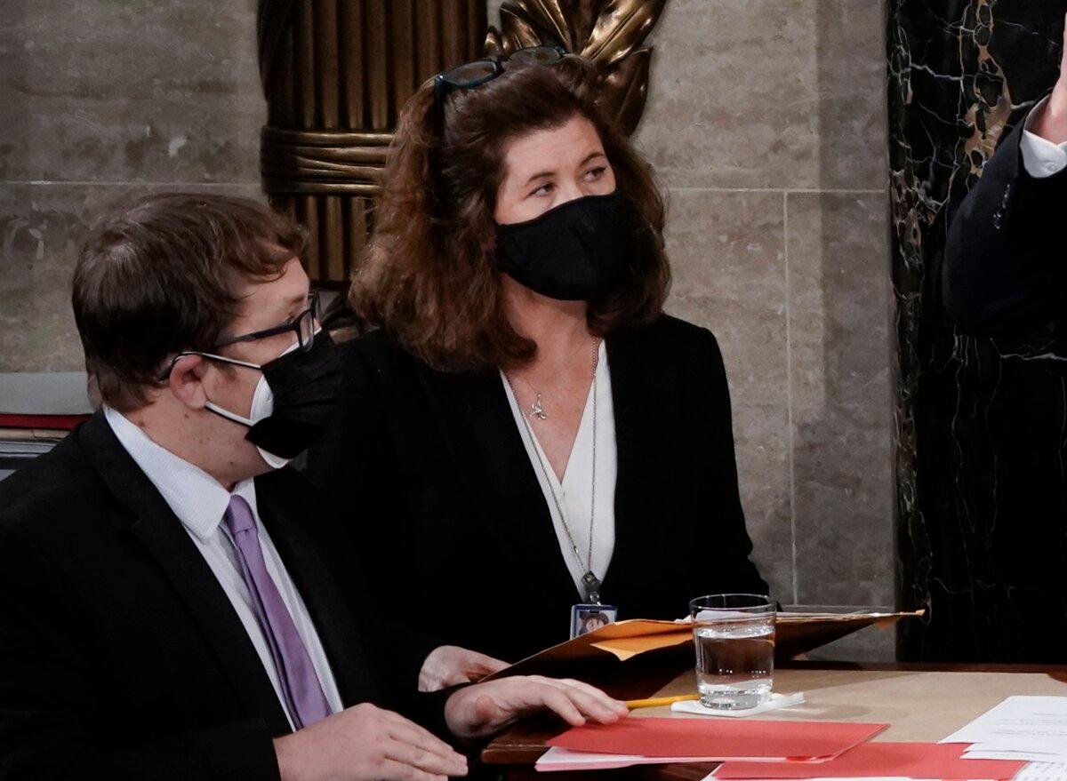 Senate Parliamentarian Elizabeth MacDonough (C) provides assistance during the certification of Electoral College ballots in the presidential election, in the House chamber at the Capitol in Washington on Jan. 6, 2021. (J. Scott Applewhite/AP Photo)