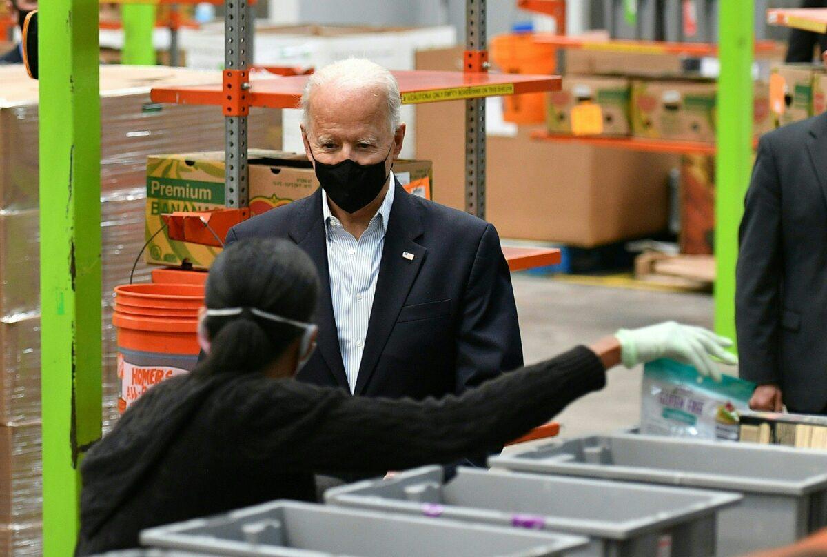 President Joe Biden talks to a volunteer during a visit at the Houston Food Bank in Texas on Feb. 26, 2021. (Mandel Ngan/AFP via Getty Images)