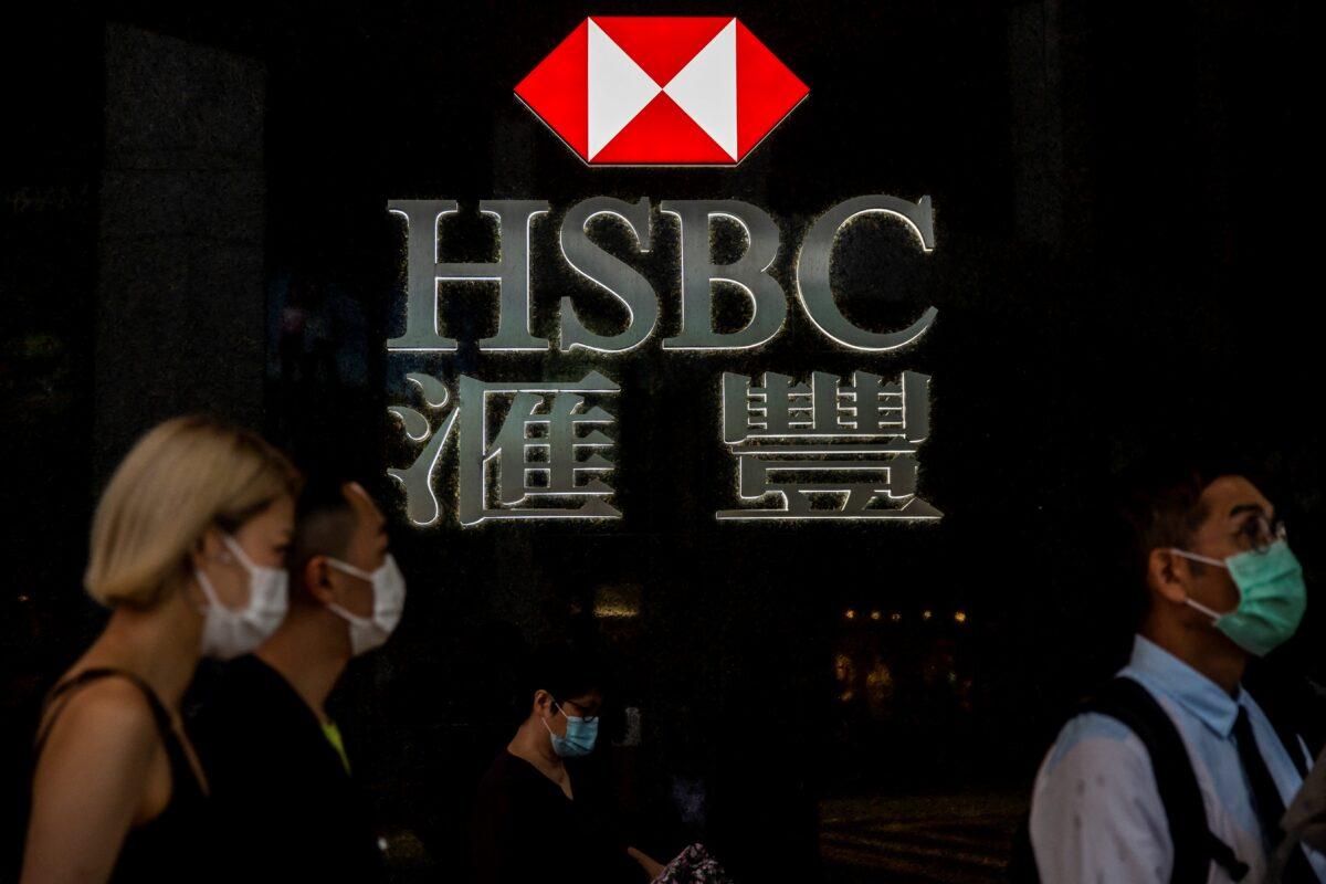 Pedestrians walking past the logo for HSBC in Hong Kong on Sept. 21, 2020. (Isaac Lawrence/AFP via Getty Images)