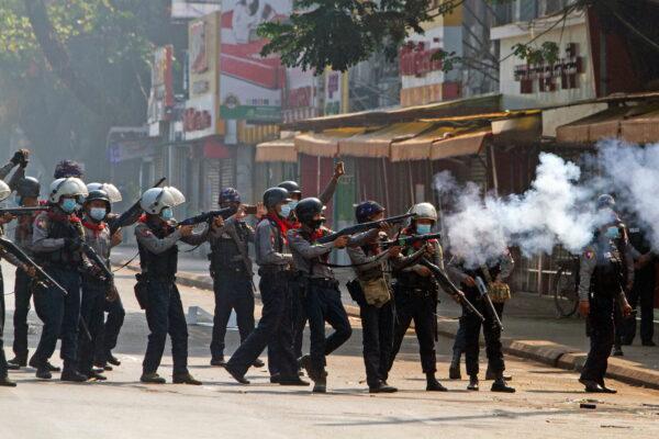 Riot police officers fire teargas canisters during a protest against the military coup in Yangon, Burma, on Feb. 28, 2021. (Stringer via Reuters)