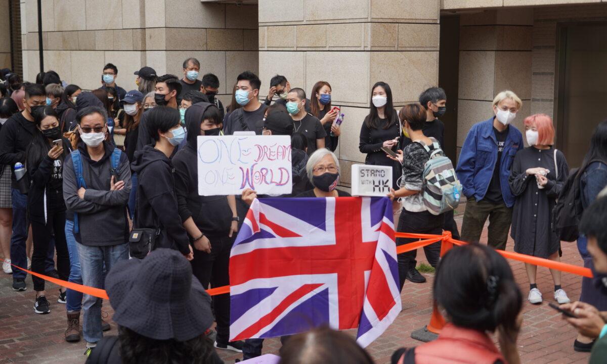 A crowd gathers outside of the West Kowloon Magistrates' Courts, where 47 dissidents charged under the Beijing-imposed national security law were about to appear in court, in Hong Kong on March 1, 2021. (Adrian Yu/The Epoch Times)