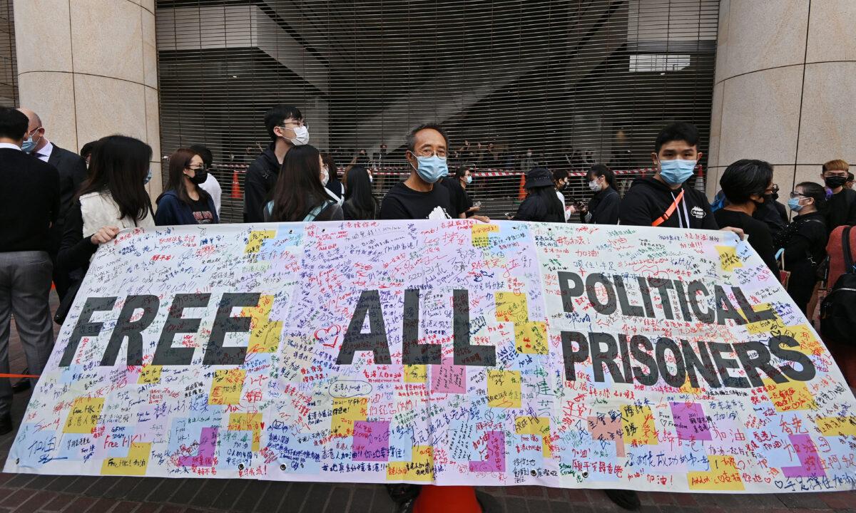 A crowd gathers outside the West Kowloon Magistrates' Courts, where 47 dissidents charged under the Beijing-imposed national security law were about to appear in court, in Hong Kong, on March 1, 2021. (Adrian Yu/The Epoch Times)