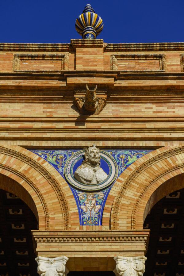Notable Spaniards peer out from medallions on the building. This image shows San Fernando who was king of Castile from 1217, king of León from 1230, and king of Galicia from 1231. Fernando was canonized in the 17th century. (Hans C. Schrodter/Shutterstock.com)