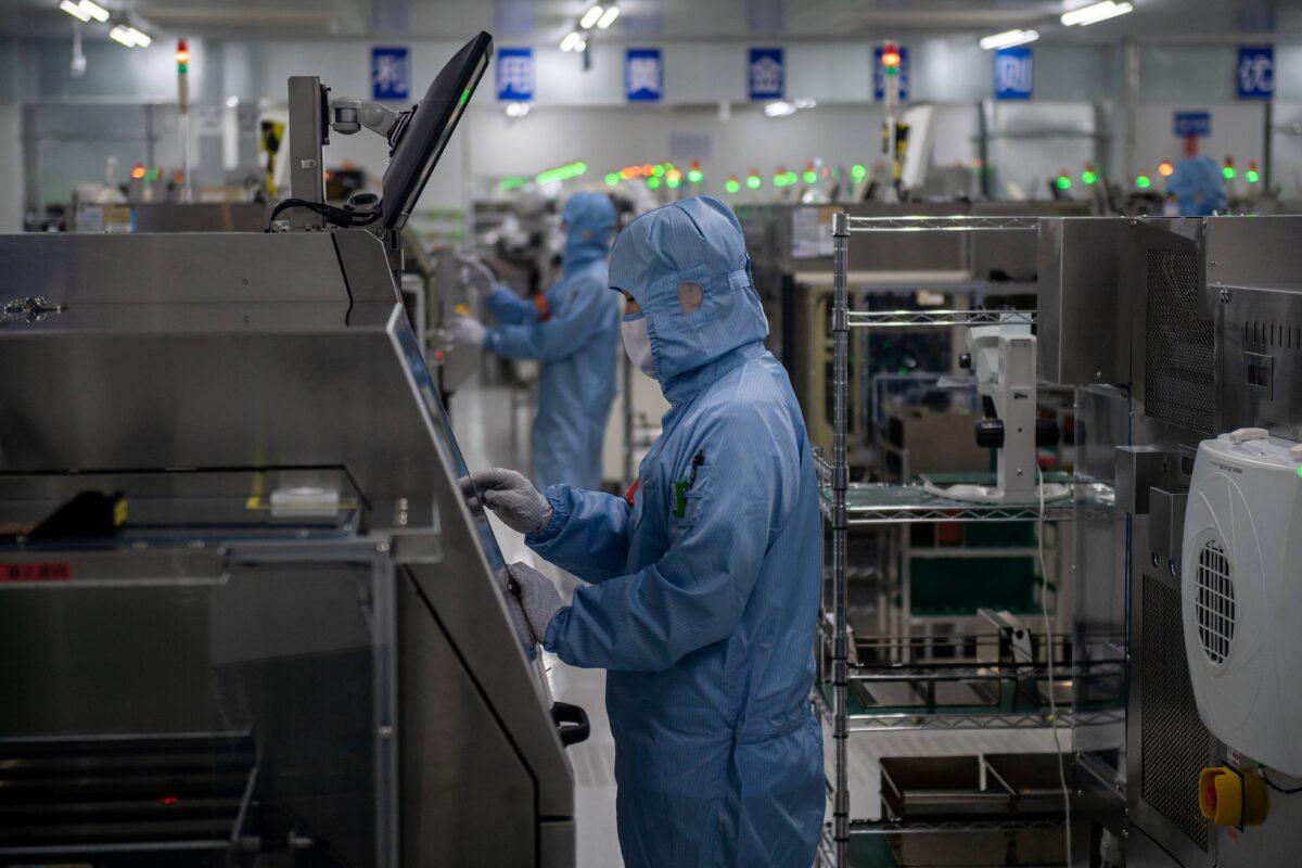 Workers are seen inside the production chain at a semiconductor manufacturing factory in Beijing on May 14, 2020. (Nicolas Asfouri/AFP via Getty Images)