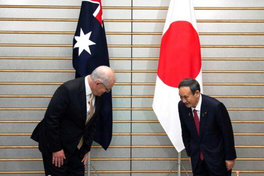 Australia's Prime Minister Scott Morrison (L) and Japan's Prime Minister Yoshihide Suga (R) bow at the start of their meeting at Suga's official residence in Tokyo, Japan, on Nov. 17, 2020. (EUGENE HOSHIKO/POOL/AFP via Getty Images)