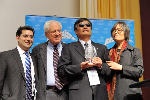 Blind Chinese rights activist and exiled dissident Chen Guangcheng (2nd R) receives the 2014 Geneva Summit Courage Award at the Geneva Summit for Human Rights and Democracy in Switzerland on Feb. 25, 2014, pictured with UN Watch executive director Hillel Neuer (1st L), UN Watch chair Alfred H. Moses (2nd L), and Chen’s wife Yuan Weijing. (Courtesy Hillel Neuer)