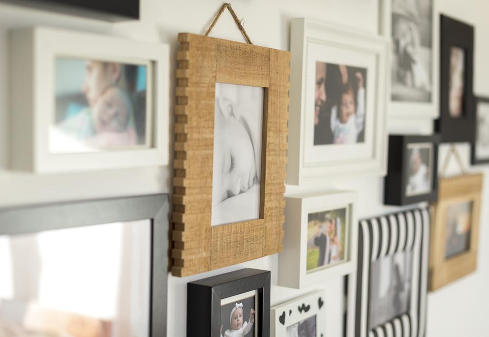 Placing photographs where they can be admired will remind your entire household of parties, vacations, and gatherings past. (OndroM/Shutterstock)