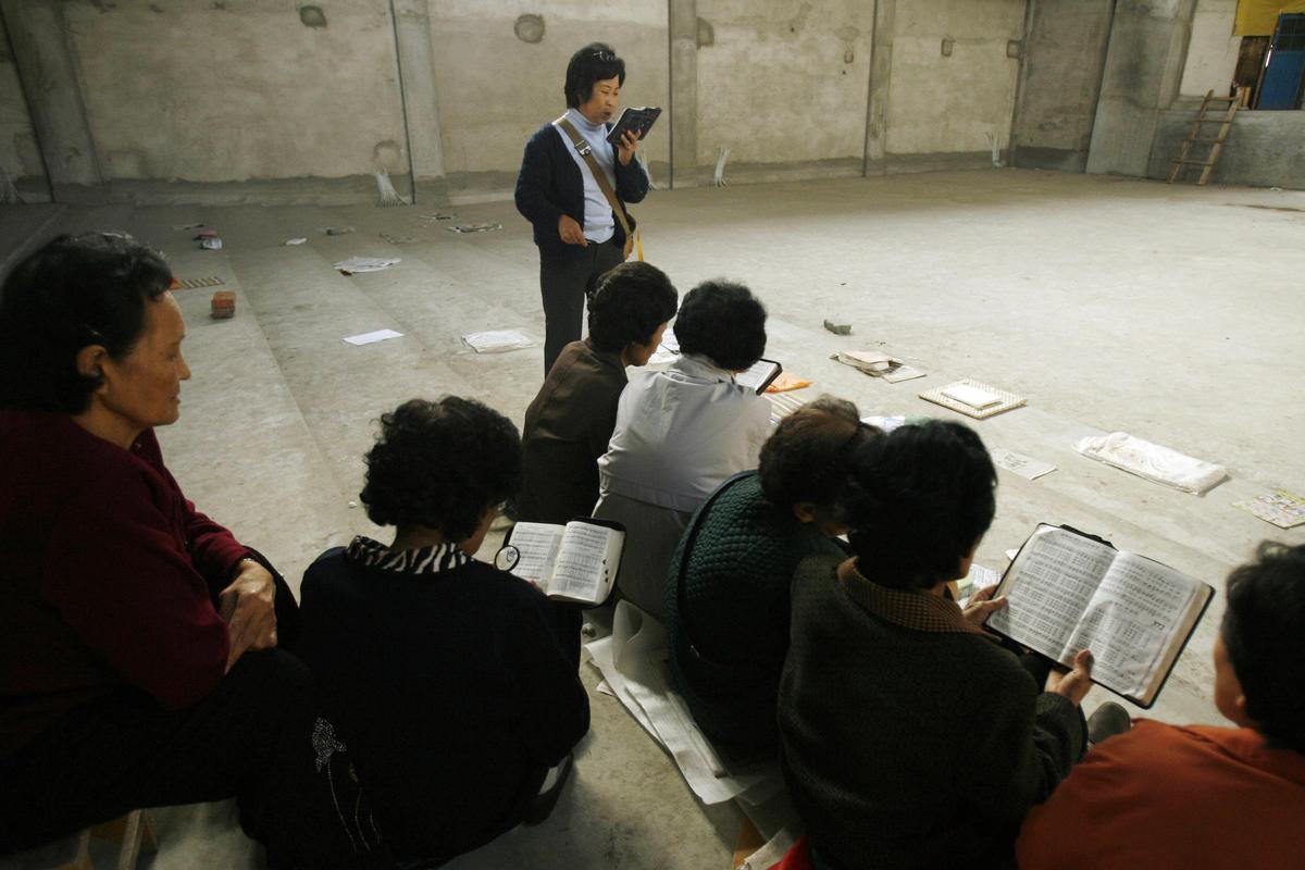Ethnic Korean Christians sing hymns in their half-finished church in the town of Yanji in Yanbian Korean Autonomous Prefecture on the China/North Korea border on Oct. 13, 2006. (Peter Parks/AFP via Getty Images)