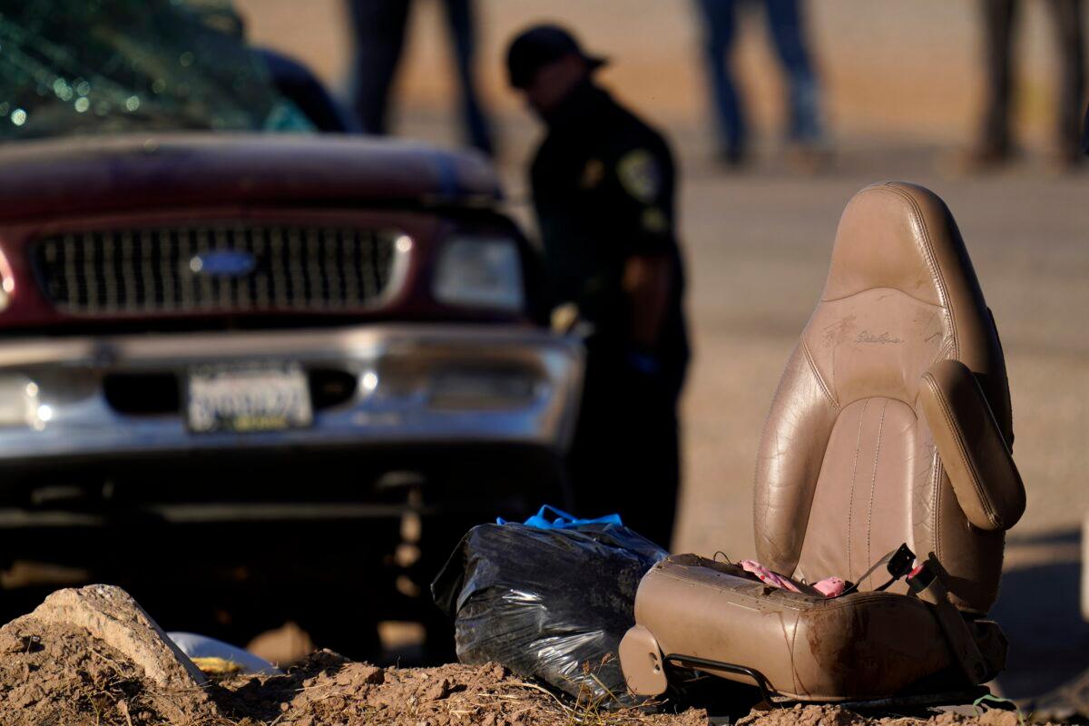 A law enforcement officer examines the scene of a deadly crash in Holtville, Calif., on March 2, 2021. (Gregory Bull/AP Photo)