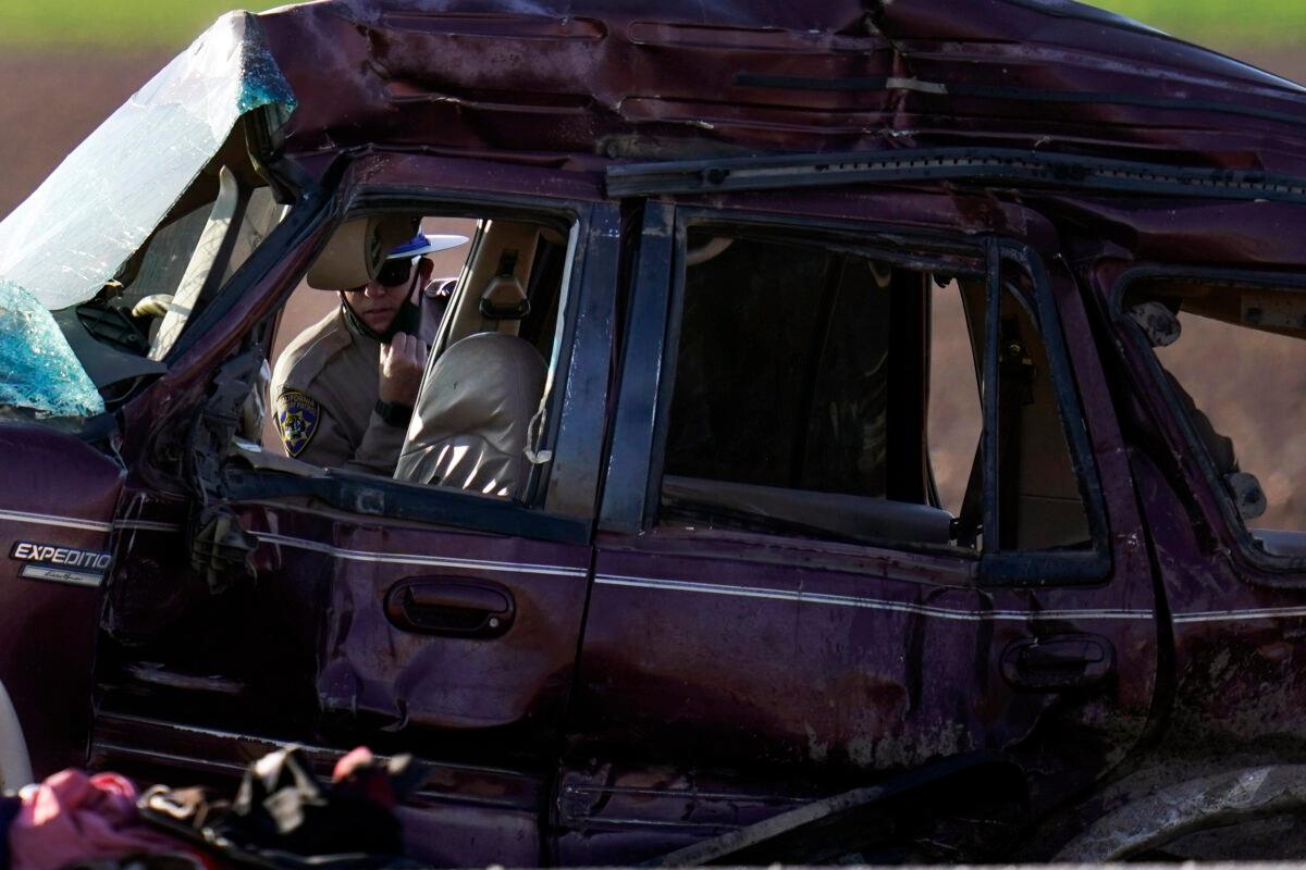 A California Highway Patrol officer examines the scene of a deadly crash in Holtville, Calif., on March 2, 2021. (Gregory Bull/AP Photo)