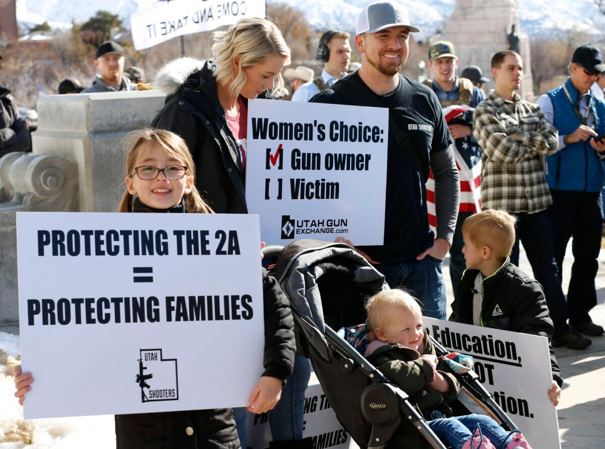 A family listens to speakers at a protest to new gun legislation at the Utah State Capitol in Salt Lake City, Utah on Feb. 8, 2020. (George Frey/AFP via Getty Images)