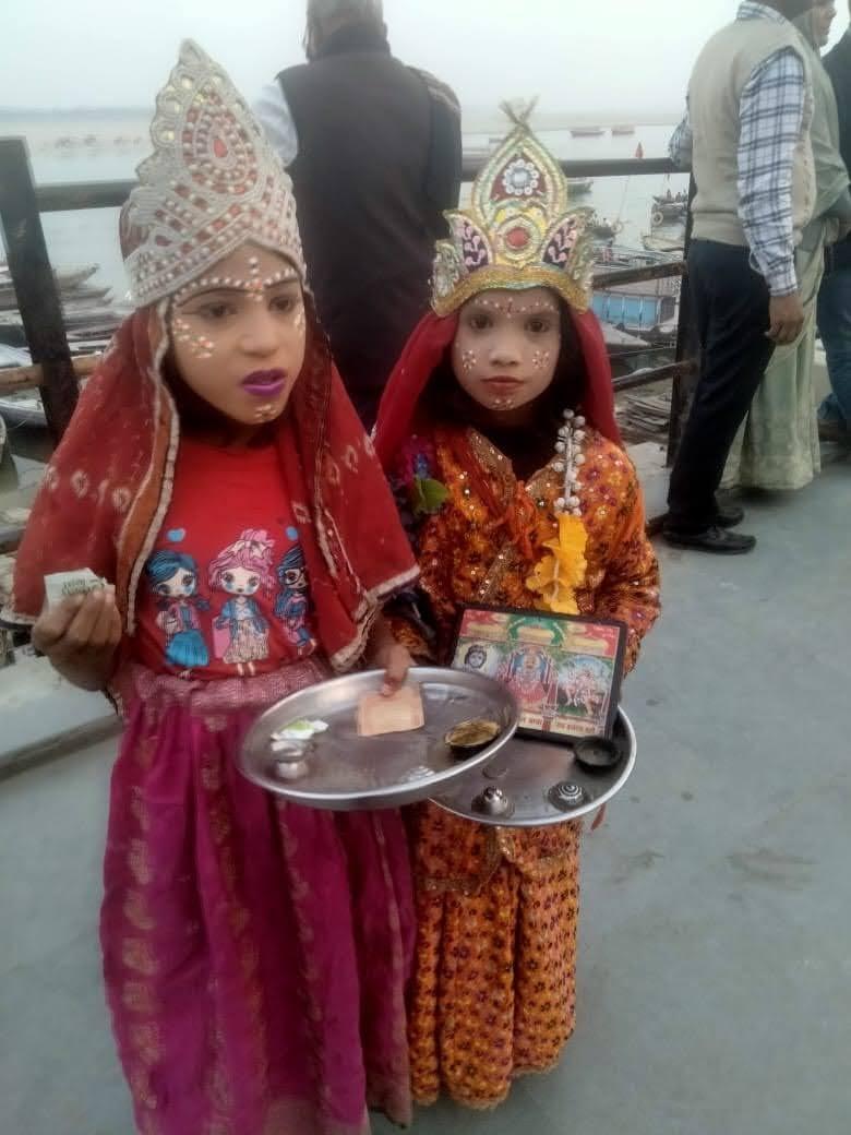 Two child beggars dressed as goddesses seek coins on the banks of the Ganges in Varanasi. (Courtesy Common Man Trust)