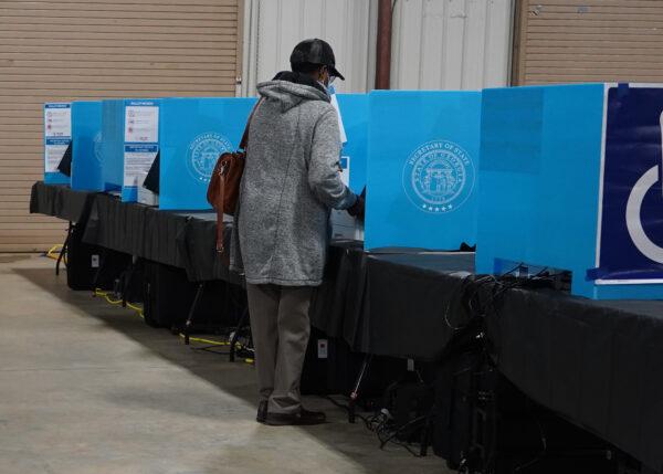 Georgia voters mark their ballots during the first day of early voting in the U.S. Senate runoffs at the Gwinnett County Fairgrounds in Atlanta, Ga., on Dec. 14, 2020. (Tami Chappell/AFP via Getty Images)