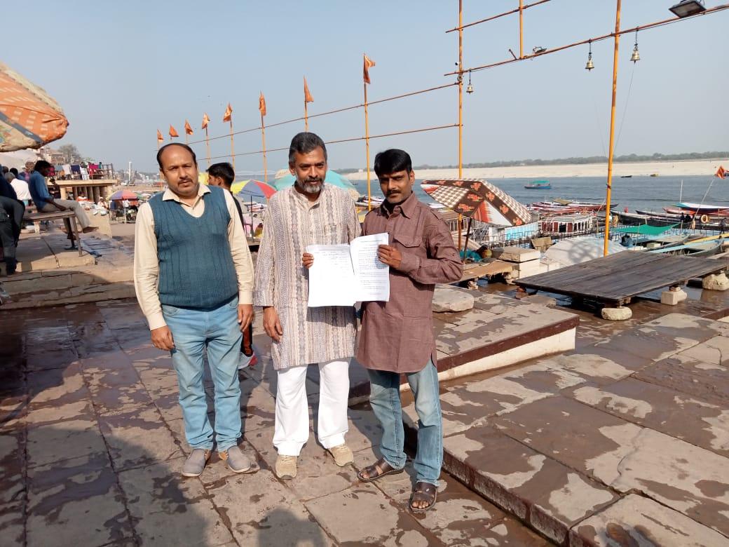 Chandra Mishra (C) of the Common Man Trust with his colleagues hold signatures they collected from shopkeepers in support of the Beggars Corporation in Varanasi, India, on Feb. 19, 2021 (Venus Upadhayaya/Epoch Times)