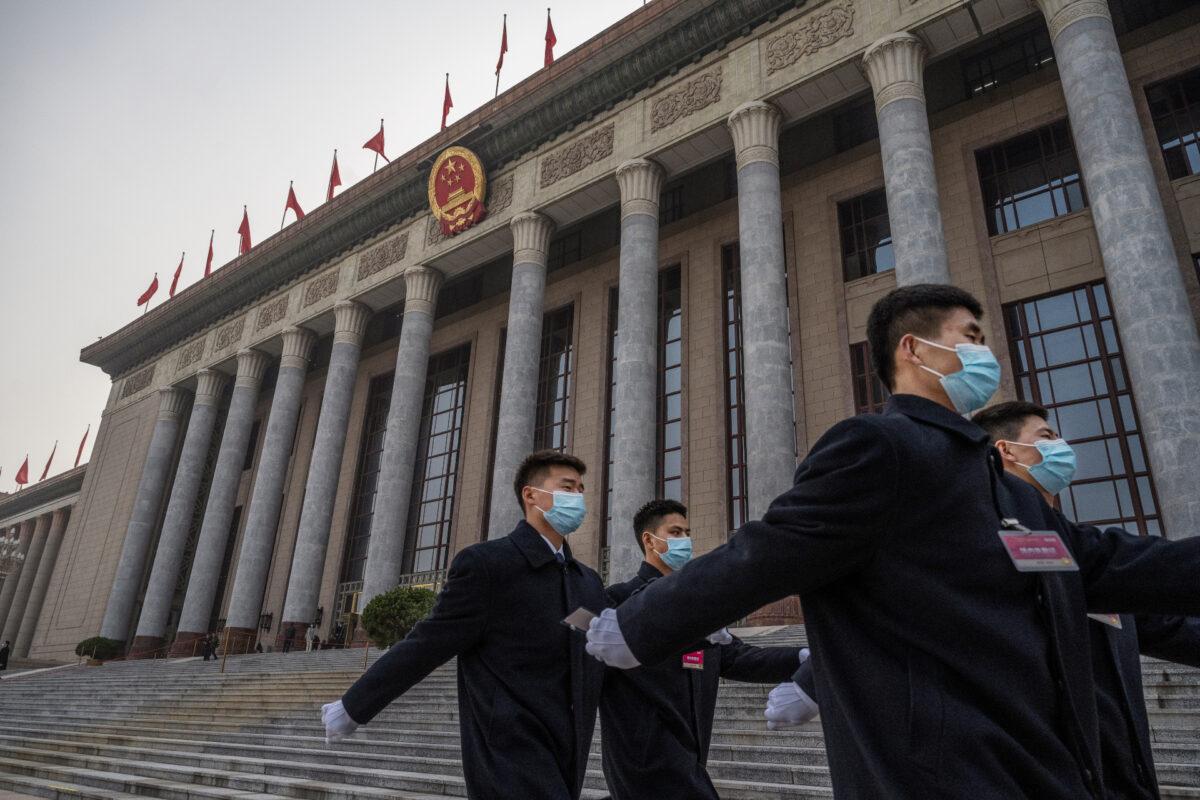 Chinese security personnel march after the opening session of the Chinese People's Political Consultative Conference at the Great Hall of the People in Beijing, on March 4, 2021. (Kevin Frayer/Getty Images)