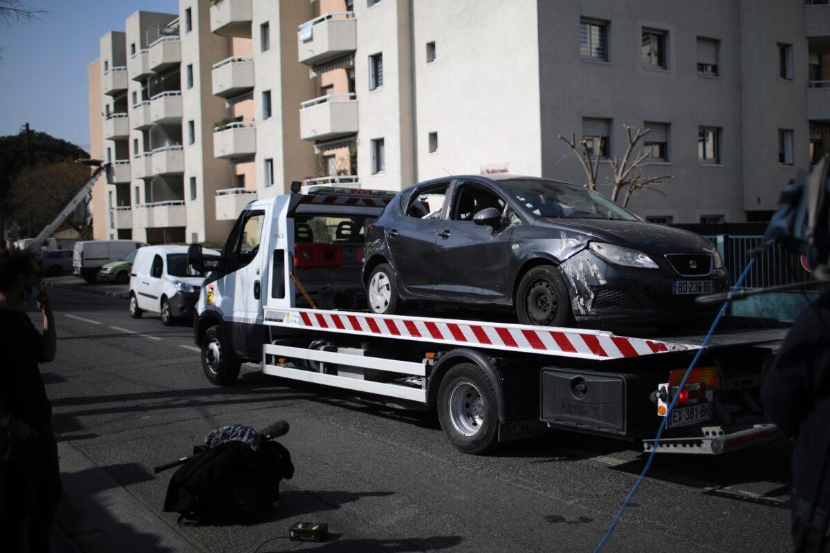 Police officers remove a suspect's car after a man visibly brandished a knife outside a Jewish school and a kosher market in Marseille, southern France, on March 5, 2021. (Daniel Cole/AP Photo)
