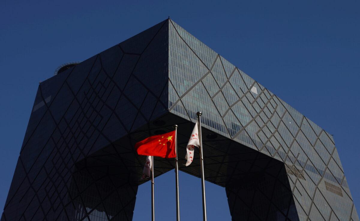 A Chinese flag flutters outside the CCTV headquarters, home of Chinese state media outlet CCTV and its English-language sister channel CGTN, in Beijing, on Feb. 5, 2021. (Carlos Garcia Rawlins via Reuters)