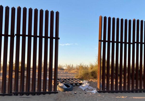 This file photo shows a hole cut into Southern California's border fence with Mexico on March 3, 2021. (U.S. Customs and Border Protection via AP)