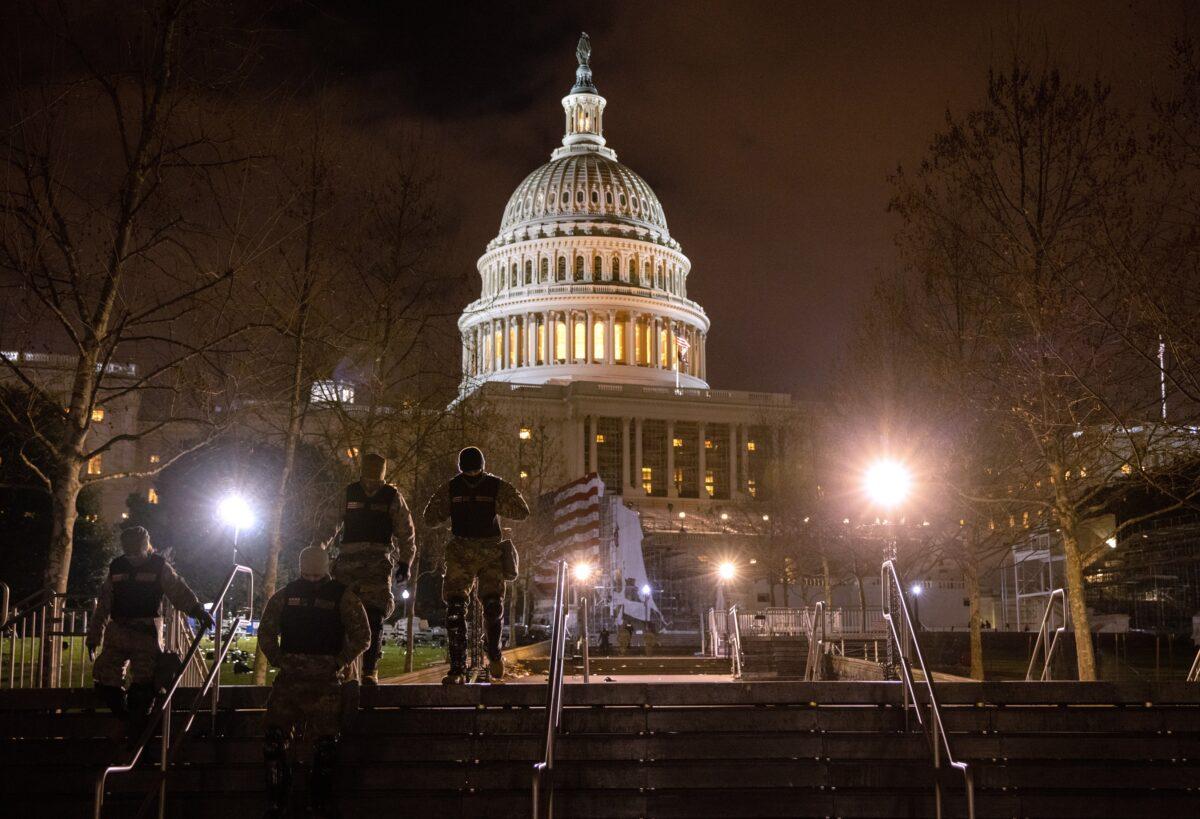 National Guard troops walk through the grounds of the Capitol in Washington on Jan. 6, 2021. (John Moore/Getty Images)